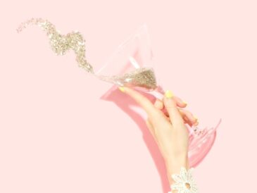 person holding clear martini glass